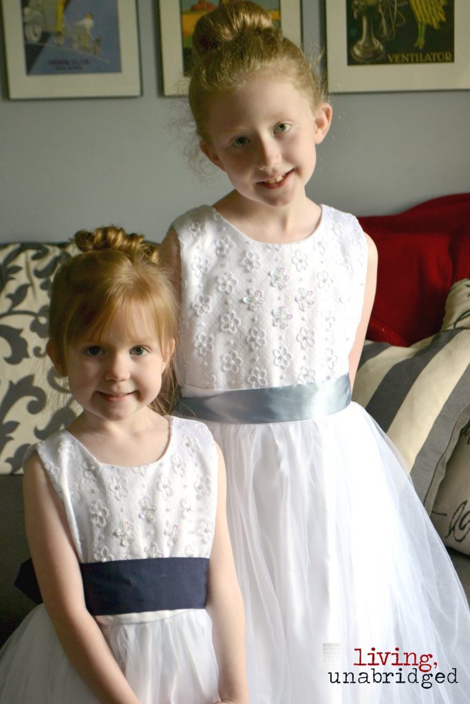 girls in white dresses with blue satin sashes